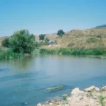 An archival view of the Litani River flowing through a valley in southern Lebanon, which currently marks the geographic boundary of the military buffer zone targeted by the advancing Israeli army.