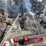 Aerial view of a destroyed residential building in Kyiv with firefighters responding after Russian missile strikes on May 24, 2026