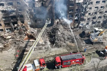 Aerial view of a destroyed residential building in Kyiv with firefighters responding after Russian missile strikes on May 24, 2026