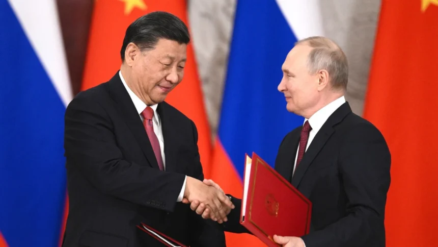 Vladimir Putin and Xi Jinping shake hands during a Russia-China bilateral signing ceremony