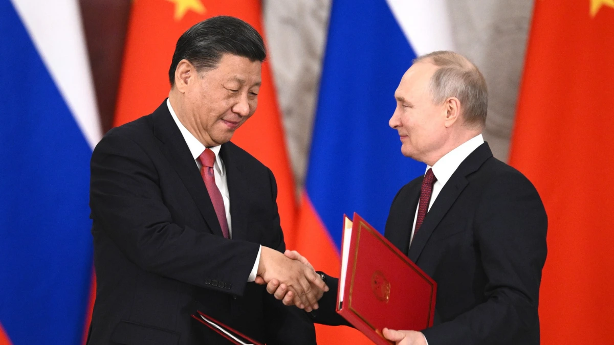 Vladimir Putin and Xi Jinping shake hands during a Russia-China bilateral signing ceremony