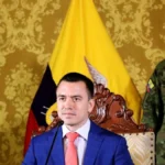 Ecuadorian President Daniel Noboa, seated before the national flag at Carondelet Palace alongside a military officer, presents designs for new high-security prison facilities on January 11, 2024, two days after declaring an internal armed conflict against criminal gangs