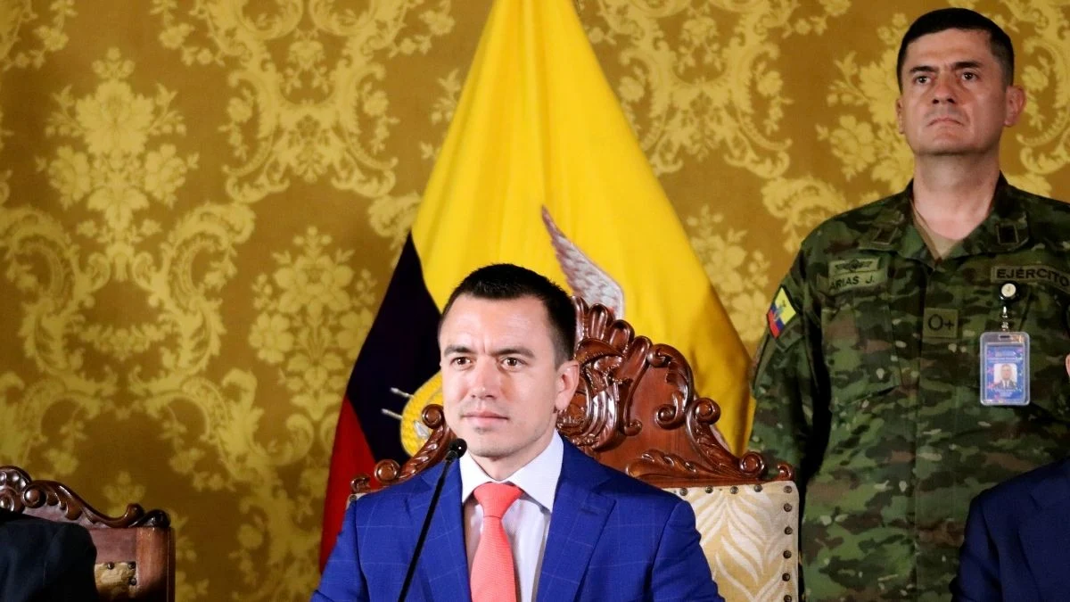 Ecuadorian President Daniel Noboa, seated before the national flag at Carondelet Palace alongside a military officer, presents designs for new high-security prison facilities on January 11, 2024, two days after declaring an internal armed conflict against criminal gangs