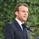 French President Emmanuel Macron speaking at a podium