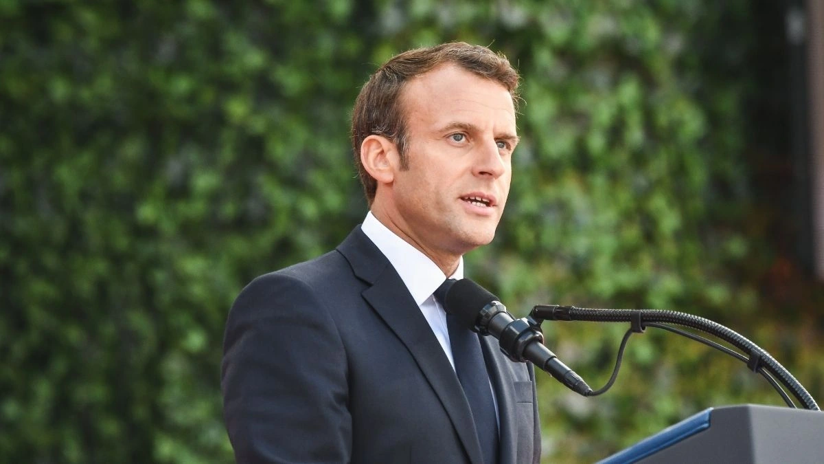French President Emmanuel Macron speaking at a podium