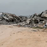 A Palestinian child walks through the ruins of homes destroyed by Israeli forces in northern Gaza during the ceasefire period, 2025
