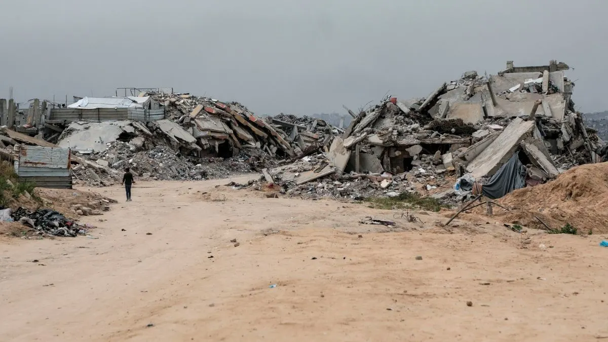 A Palestinian child walks through the ruins of homes destroyed by Israeli forces in northern Gaza during the ceasefire period, 2025