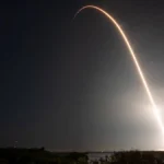 A SpaceX Falcon 9 rocket traces a bright arc across the pre-dawn sky during the Crew-6 mission launch, photographed in a five-minute long exposure at NASA's Kennedy Space Center, Florida.
