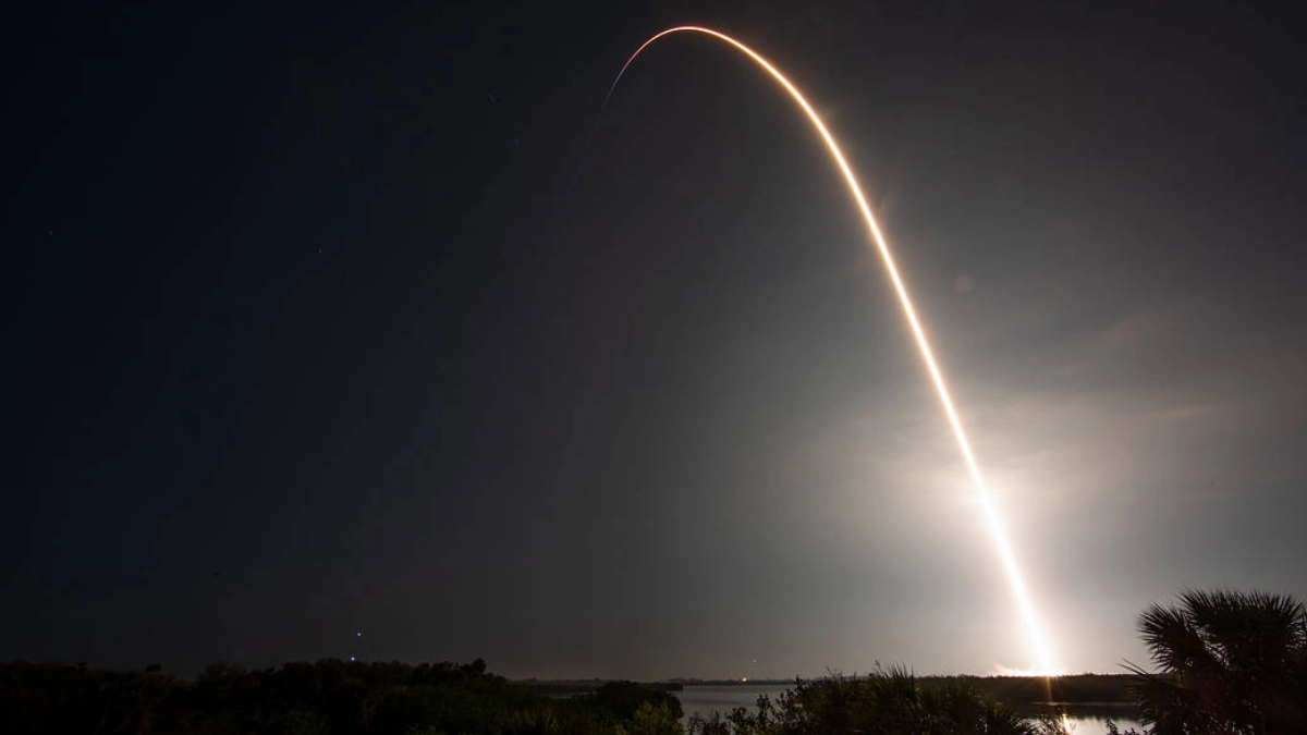 A SpaceX Falcon 9 rocket traces a bright arc across the pre-dawn sky during the Crew-6 mission launch, photographed in a five-minute long exposure at NASA's Kennedy Space Center, Florida.