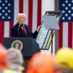 President Donald Trump holding a tariff chart during a press event in the White House Rose Garden in April 2025.