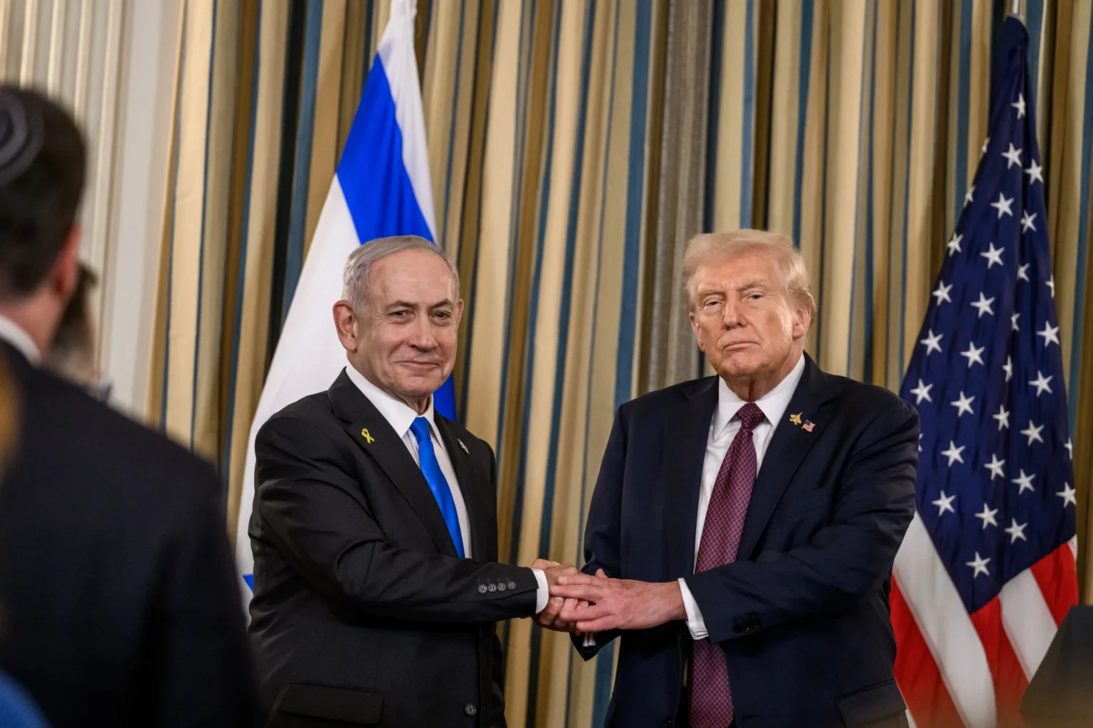 U.S. President Donald Trump and Israeli Prime Minister Benjamin Netanyahu shaking hands during a joint press conference at the White House