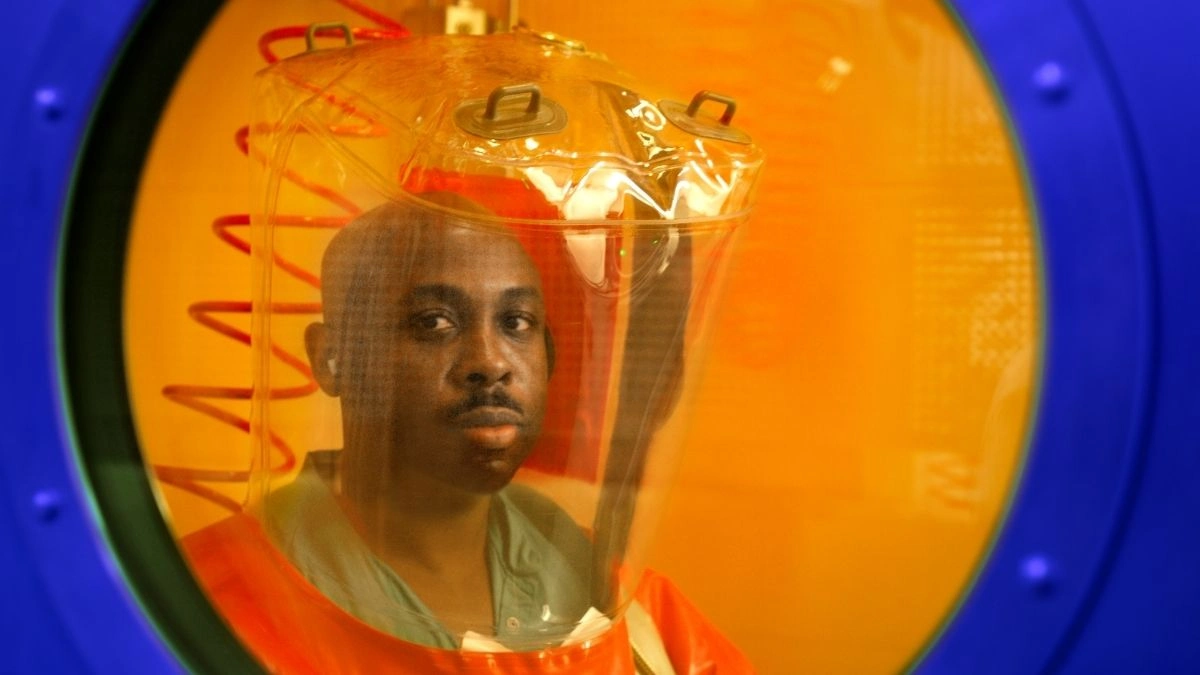 A CDC microbiologist inside a BSL-4 high containment laboratory, the type of facility used in the US-funded global biolab network spanning 30 countries